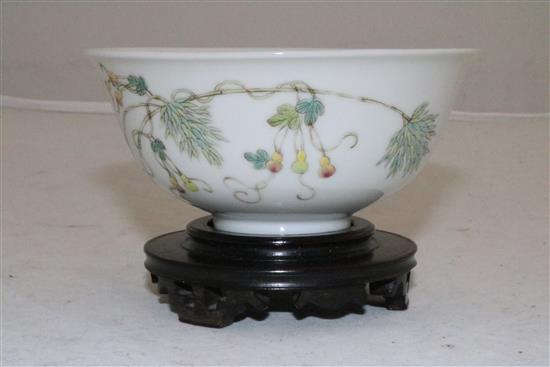 A Chinese famille rose bowl, diameter 10.8cm, wood stand